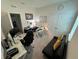 Spacious home office with multiple desks, a futon, and ample lighting for a productive workspace at 33034 Sand Creek Dr, Wesley Chapel, FL 33543