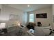 Functional home office featuring dual desks, neutral colors, and a comfortable futon for versatile use at 33034 Sand Creek Dr, Wesley Chapel, FL 33543