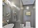 Stylish half bathroom with a marble sink and decorative gray accent wall at 3435 Bayshore Blvd # 2100P, Tampa, FL 33629