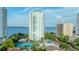 Exterior view showcasing a high-rise building near the bay with a pool and tennis court at 3435 Bayshore Blvd # 2100P, Tampa, FL 33629