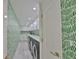 Long laundry room with side by side washer and dryer and decorated with patterned wallpaper at 3435 Bayshore Blvd # 2100P, Tampa, FL 33629