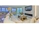 Bright living room featuring a water view, modern fireplace, and comfortable seating at 3435 Bayshore Blvd # 2100P, Tampa, FL 33629