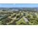 Expansive aerial view showcasing the lush golf course, scenic ponds, and verdant surroundings at 36750 Us 19 N # 24-104, Palm Harbor, FL 34684