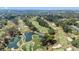 Breathtaking aerial perspective of the golf course, highlighting its serene pond and lush fairways at 36750 Us 19 N # 24-104, Palm Harbor, FL 34684