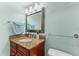 Bathroom featuring vanity with granite countertop, framed mirror and modern lighting at 36750 Us 19 N # 24-104, Palm Harbor, FL 34684