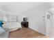 Bedroom offers hardwood flooring, a mounted TV, and a sofa for added comfort at 36750 Us 19 N # 24-104, Palm Harbor, FL 34684