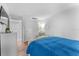 This bedroom offers storage with a closet and dresser, plus a side table with lamp and decorative mirror at 36750 Us 19 N # 24-104, Palm Harbor, FL 34684