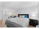 Relaxing bedroom has hardwood floors, plus a lounge area with sofa across from the bed at 36750 Us 19 N # 24-104, Palm Harbor, FL 34684