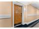 The front door is stained wood, number 3384, and is located in a neutral hallway with classic trim at 36750 Us 19 N # 24-104, Palm Harbor, FL 34684