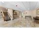 A spacious hallway features tile flooring, a brick staircase, seating, and a ceiling with recessed lighting at 36750 Us 19 N # 24-104, Palm Harbor, FL 34684