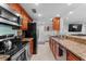 Well-equipped kitchen featuring granite countertops, stainless steel appliances, and ample storage at 36750 Us 19 N # 24-104, Palm Harbor, FL 34684