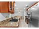 Kitchen featuring granite countertops, stainless steel appliances, and view of dining room at 36750 Us 19 N # 24-104, Palm Harbor, FL 34684