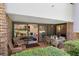 Outdoor patio featuring brick flooring, and furniture, with sliders leading to living area at 36750 Us 19 N # 24-104, Palm Harbor, FL 34684