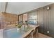 Patio boasts an outdoor dining area, brick accents, and a view to the home's interior at 36750 Us 19 N # 24-104, Palm Harbor, FL 34684
