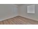 A simple bedroom with light-colored faux-wood floors, neutral walls, blinds and trim at 3751 Pompano Se Dr # 3751, St Petersburg, FL 33705