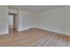 A clean, bright bedroom with an open door, white walls, wood floors, and a closet at 3751 Pompano Se Dr # 3751, St Petersburg, FL 33705