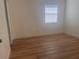 A simple bedroom with light-colored faux-wood floors, neutral walls, blinds and trim at 3751 Pompano Se Dr # 3751, St Petersburg, FL 33705