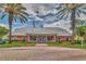 Exterior of clubhouse featuring a well-manicured lawn, flagpole and ample parking, creating an inviting community space at 3751 Pompano Se Dr # 3751, St Petersburg, FL 33705