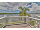 Scenic waterfront view from a private deck with white railing and a large palm tree at 3751 Pompano Se Dr # 3751, St Petersburg, FL 33705