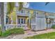 Exterior view of a yellow condo building with multiple balconies and well-maintained landscaping at 3751 Pompano Se Dr # 3751, St Petersburg, FL 33705