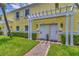Charming townhouse entrance featuring well-maintained landscaping and a pergola over the doorways at 3751 Pompano Se Dr # 3751, St Petersburg, FL 33705