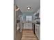 Galley kitchen featuring stainless steel appliances, white cabinetry, and stylish subway tile backsplash at 3751 Pompano Se Dr # 3751, St Petersburg, FL 33705