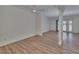 Spacious open-plan living room with contemporary wood-look flooring and neutral wall color at 3751 Pompano Se Dr # 3751, St Petersburg, FL 33705