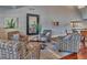 Welcoming lounge area featuring patterned armchairs, elegant decor, and hardwood floors for relaxation at 3751 Pompano Se Dr # 3751, St Petersburg, FL 33705