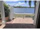 Water view from the covered patio, framed by white pillars and a brick-paved floor, provides a serene waterfront experience at 3751 Pompano Se Dr # 3751, St Petersburg, FL 33705