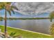 Expansive waterfront view, highlighted by lush green grass and palm trees, providing a tropical oasis at 3751 Pompano Se Dr # 3751, St Petersburg, FL 33705
