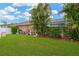 Expansive backyard with lush lawn, privacy fence, and screened pool enclosure for outdoor living and entertainment at 3913 Little Egret Ct, Lutz, FL 33558