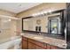 Bathroom featuring granite counters, ample lighting, tile flooring and a shower with glass doors at 3913 Little Egret Ct, Lutz, FL 33558