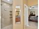 Bathroom featuring tile shower, granite counters, vanity with mirror, and doorway view to bedroom at 3913 Little Egret Ct, Lutz, FL 33558