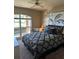 Comfortable bedroom featuring a ceiling fan and a window view to the exterior patio at 3913 Little Egret Ct, Lutz, FL 33558