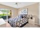 Inviting bedroom featuring a queen-sized bed, modern decor, and access to the balcony at 3913 Little Egret Ct, Lutz, FL 33558