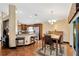 Open floor plan reveals a kitchen with stainless steel appliances, granite countertops, and bar seating at 3913 Little Egret Ct, Lutz, FL 33558