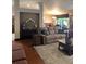 Spacious living room features a plush sofa, wood floors, dining area in the background at 3913 Little Egret Ct, Lutz, FL 33558