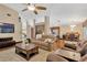Spacious living room with high ceilings, wood floors, and an open floor plan to the kitchen and dining area at 3913 Little Egret Ct, Lutz, FL 33558