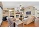 Inviting living room with a brick fireplace, built-in shelving, and comfortable reclining furniture at 3913 Little Egret Ct, Lutz, FL 33558