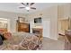 Bedroom features a fireplace, ceiling fan and ensuite bath at 3913 Little Egret Ct, Lutz, FL 33558