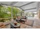 Relaxing screened-in patio with comfortable seating and a view of the pool and lush landscaping at 3913 Little Egret Ct, Lutz, FL 33558