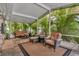 Screened-in patio with seating area, lush tropical plants and access to the backyard at 3913 Little Egret Ct, Lutz, FL 33558