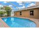 Sparkling in-ground pool with screened enclosure providing a private outdoor oasis for swimming and leisure at 3913 Little Egret Ct, Lutz, FL 33558