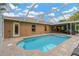 Inviting in-ground pool with screened enclosure and brick paver patio for outdoor relaxation and enjoyment at 3913 Little Egret Ct, Lutz, FL 33558