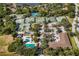 A high aerial shot showing multiple tennis courts, community pool, clubhouse, and beautiful landscaping at 4769 Stoneview Cir, Oldsmar, FL 34677
