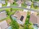 Aerial shot of a single-Gathering home with a screened-in pool and solar panels in a residential neighborhood at 4769 Stoneview Cir, Oldsmar, FL 34677