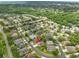 High-angle view showcasing a residential neighborhood with tree-lined streets, community ponds, and single Gathering homes at 4769 Stoneview Cir, Oldsmar, FL 34677
