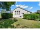 Backyard with a charming home featuring a screened-in pool and lush landscaping at 4769 Stoneview Cir, Oldsmar, FL 34677