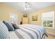 Bright bedroom features wood floors, large windows, and a coastal-themed decor at 4769 Stoneview Cir, Oldsmar, FL 34677