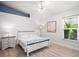 Bright bedroom with vaulted ceiling, hardwood floors, and modern decor at 4769 Stoneview Cir, Oldsmar, FL 34677